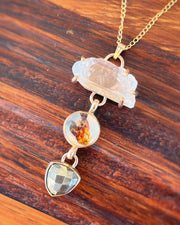 Cascading quartz point, flower terrarium, and pyrite necklace in 14K gold-fill