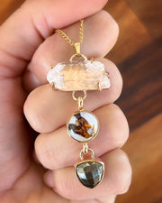 Cascading quartz point, flower terrarium, and pyrite necklace in 14K gold-fill