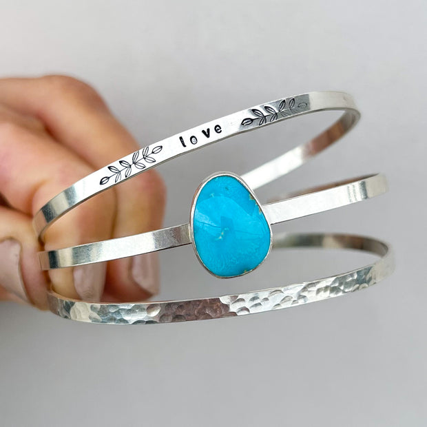 Blue turquoise "love" cuff set in silver
