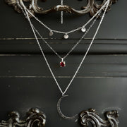 Layered moon necklace set with rhodolite garnet