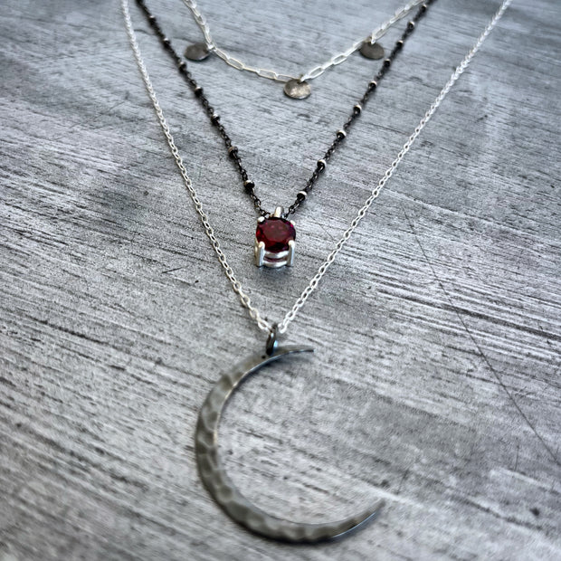 Layered moon necklace set with rhodolite garnet